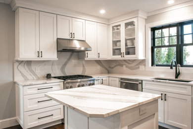 Inspiration for a mid-sized timeless u-shaped eat-in kitchen remodel in Providence with an undermount sink, shaker cabinets, white cabinets, quartz countertops, white backsplash, marble backsplash, stainless steel appliances, an island and white countertops
