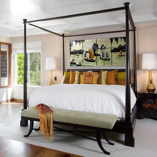 Immagine di una camera matrimoniale etnica con pavimento in legno massello medio