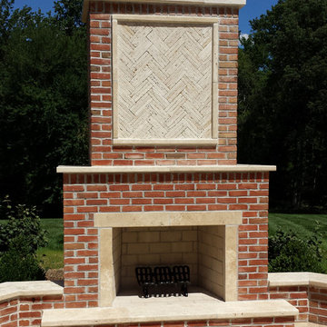 Traditional Brick Fireplace with Travertine Accents and Herringbone Inlay