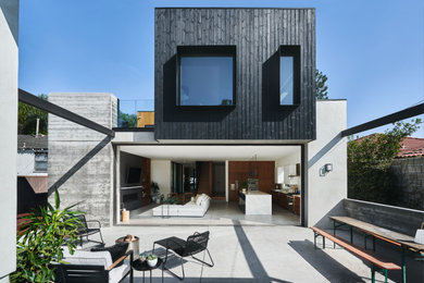 Mid-sized trendy black two-story wood exterior home photo in Los Angeles with a mixed material roof