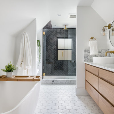 Inspiration for a large contemporary master black tile and travertine tile marble floor, gray floor and double-sink bathroom remodel in Atlanta with flat-panel cabinets, light wood cabinets, a wall-mount toilet, white walls, a vessel sink, marble countertops, a hinged shower door, white countertops and a floating vanity