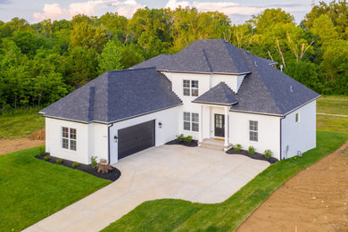 Inspiration for a transitional white two-story brick house exterior remodel in Huntington with a shingle roof