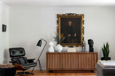 Inspiration for a mid-sized modern open concept medium tone wood floor and brown floor living room remodel in Edinburgh with white walls