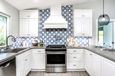 Example of a kitchen design in Miami with white cabinets