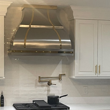 Custom Stainless Steel Range Hood in a Luxury White Kitchen