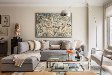 Living room - large transitional open concept medium tone wood floor living room idea in New York with beige walls and no fireplace