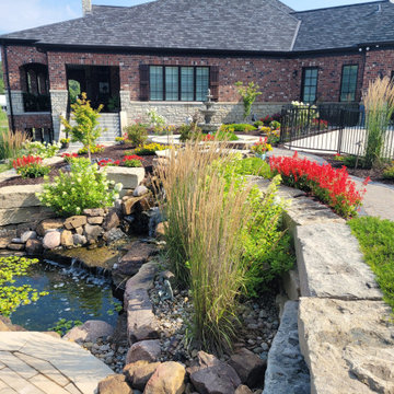 Estate Poolside Landscape & Hardscape Retreat with Custom Waterfeature