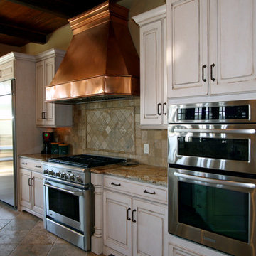Copper Hood and Exposed Brick Give Rustic Feel to this Traditional Design