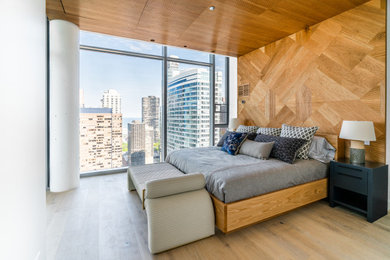 Inspiration for a large contemporary master light wood floor, brown floor, wood ceiling and wood wall bedroom remodel in Chicago