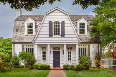 Example of a classic white two-story wood and clapboard house exterior design in DC Metro with a gambrel roof, a tile roof and a gray roof