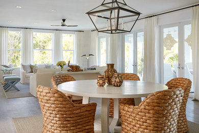 Inspiration for a coastal light wood floor and beige floor dining room remodel in Miami with white walls