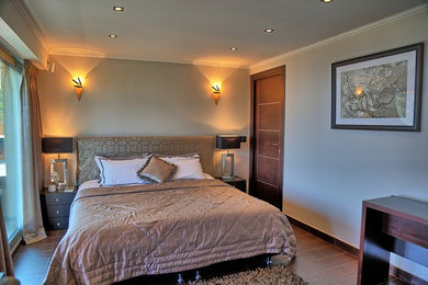Bedroom - mid-sized contemporary master bedroom idea in Other with beige walls