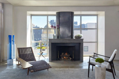 Design ideas for an expansive contemporary open concept family room in New York with a music area, grey walls, limestone floors, a standard fireplace and a metal fireplace surround.