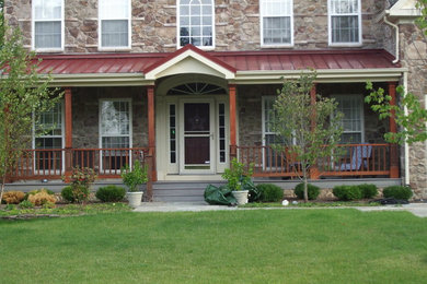 Large mountain style front porch idea in Philadelphia with a roof extension and decking