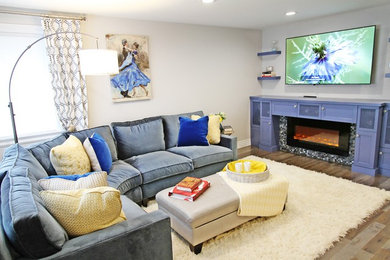 Mid-sized transitional formal and open concept medium tone wood floor and brown floor living room photo in Seattle with white walls, a standard fireplace, a tile fireplace and a wall-mounted tv