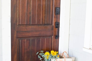 Example of a single front door design in Indianapolis with gray walls and a dark wood front door