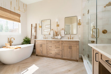 Example of a transitional master light wood floor and double-sink bathroom design in Dallas with shaker cabinets, light wood cabinets, beige walls, a hinged shower door, beige countertops and a freestanding vanity