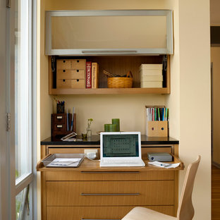 Medium sized retro home office and library in Seattle with a built-in desk, beige walls, medium hardwood flooring and no fireplace.