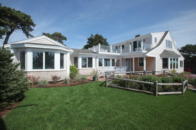 Inspiration for a mid-sized coastal white two-story wood gable roof remodel in Boston