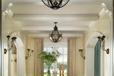 Inspiration for an expansive beach style foyer in New York with beige walls and dark hardwood floors.