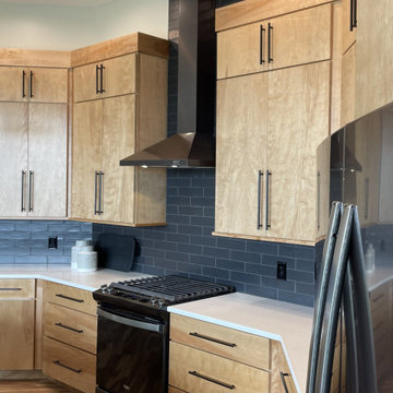 Angled Kitchen Design with Slab Style Cabinets in Pecan Stain