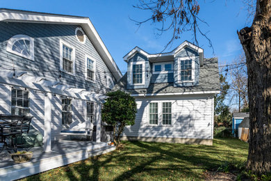 Transitional white two-story house exterior photo in Charleston with a shingle roof and a gray roof