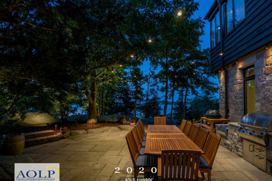 This is an example of a mid-sized coastal privacy backyard stone formal garden in Boston.