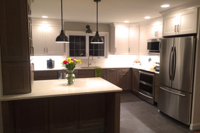 Mid-sized transitional l-shaped cement tile floor and gray floor eat-in kitchen photo in Other with a single-bowl sink, shaker cabinets, white cabinets, quartz countertops, white backsplash, subway tile backsplash, stainless steel appliances, a peninsula and white countertops