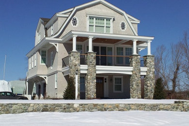 Mid-sized beach style beige three-story wood house exterior photo in Bridgeport with a gambrel roof and a tile roof