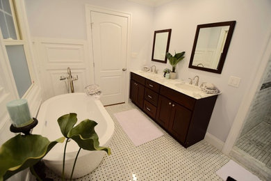 Bathroom - mid-sized traditional master gray tile and ceramic tile ceramic tile bathroom idea in New York with shaker cabinets, dark wood cabinets, a two-piece toilet, blue walls, an undermount sink and granite countertops