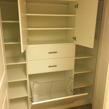 Master closet in white with hamper drawers & doors