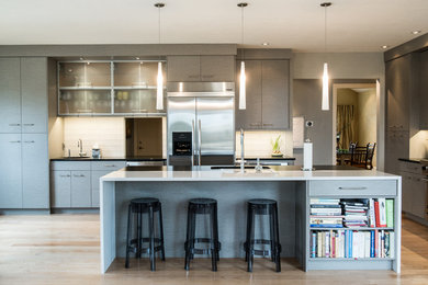 Kitchen - contemporary kitchen idea in Other with a single-bowl sink, quartz countertops, glass tile backsplash, stainless steel appliances, white backsplash and an island