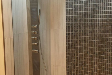 Example of a mid-sized trendy master multicolored tile ceramic tile doorless shower design in Nashville with a one-piece toilet, a vessel sink, granite countertops and beige walls