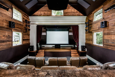 Home theater - rustic home theater idea in Other with brown walls and a projector screen