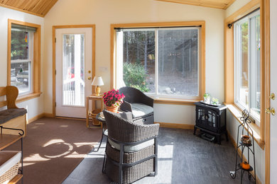This is an example of a small beach style sunroom in Boston with a skylight, ceramic floors and black floor.
