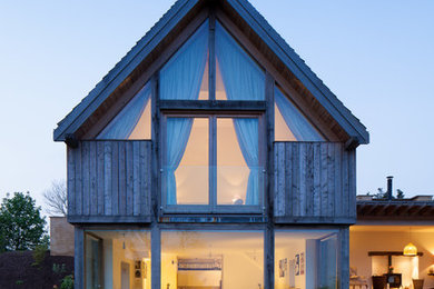 Inspiration for a contemporary two-storey exterior in Gloucestershire with mixed siding.