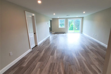 Large transitional walk-out vinyl floor basement photo