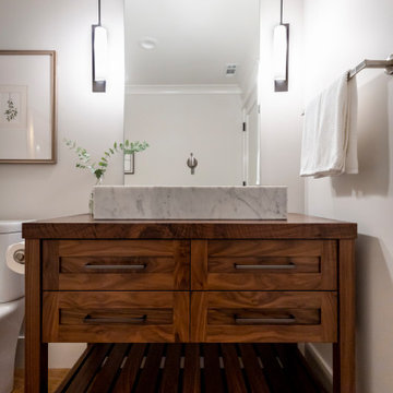 Walnut Bathroom Vanity with Marble Vessel Sink and Pendant Lighting