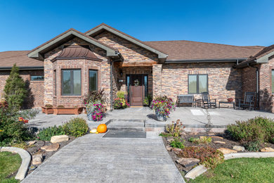 Inspiration for a huge eclectic brown one-story brick and shingle exterior home remodel in Denver with a shingle roof and a brown roof