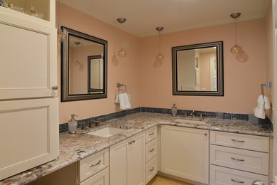 Mid-sized trendy master black tile and matchstick tile light wood floor bathroom photo in Other with recessed-panel cabinets, white cabinets, pink walls, an undermount sink and granite countertops