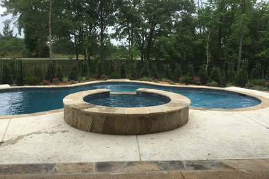 Example of a mid-sized classic backyard concrete lap hot tub design in Austin