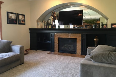 Inspiration for a timeless carpeted and gray floor living room remodel in Other with beige walls, a standard fireplace and a stone fireplace