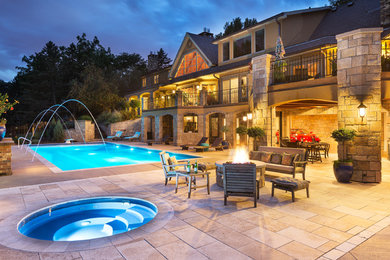 Inspiration for a large mediterranean backyard rectangular lap pool in Minneapolis with a hot tub and concrete pavers.