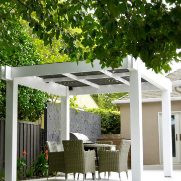 Daytime View of Pergola, Dining Area, and Outdoor Kitchen Privacy Screen