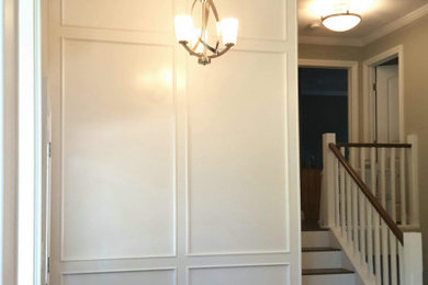 Staircase - wooden straight wood railing staircase idea in Edmonton with painted risers