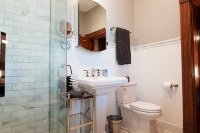 Inspiration for a mid-sized transitional 3/4 white tile and stone tile mosaic tile floor corner shower remodel in Columbus with a two-piece toilet, beige walls and a pedestal sink