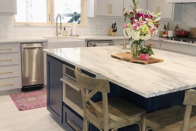Example of a cottage kitchen design in Dallas with an island and white countertops