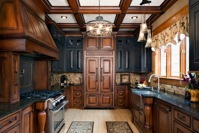 Elegant multicolored floor and porcelain tile kitchen photo in Other with an undermount sink, raised-panel cabinets, distressed cabinets, quartz countertops, yellow backsplash, travertine backsplash, no island, black countertops and paneled appliances