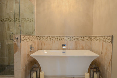 Example of a mid-sized transitional master beige tile and porcelain tile porcelain tile bathroom design in Austin with an undermount sink, shaker cabinets, gray cabinets, solid surface countertops and beige walls