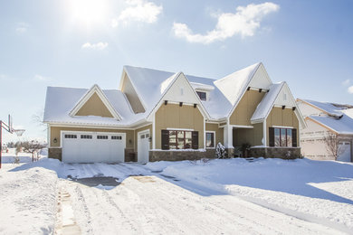 Large craftsman brown one-story concrete fiberboard gable roof idea in Grand Rapids